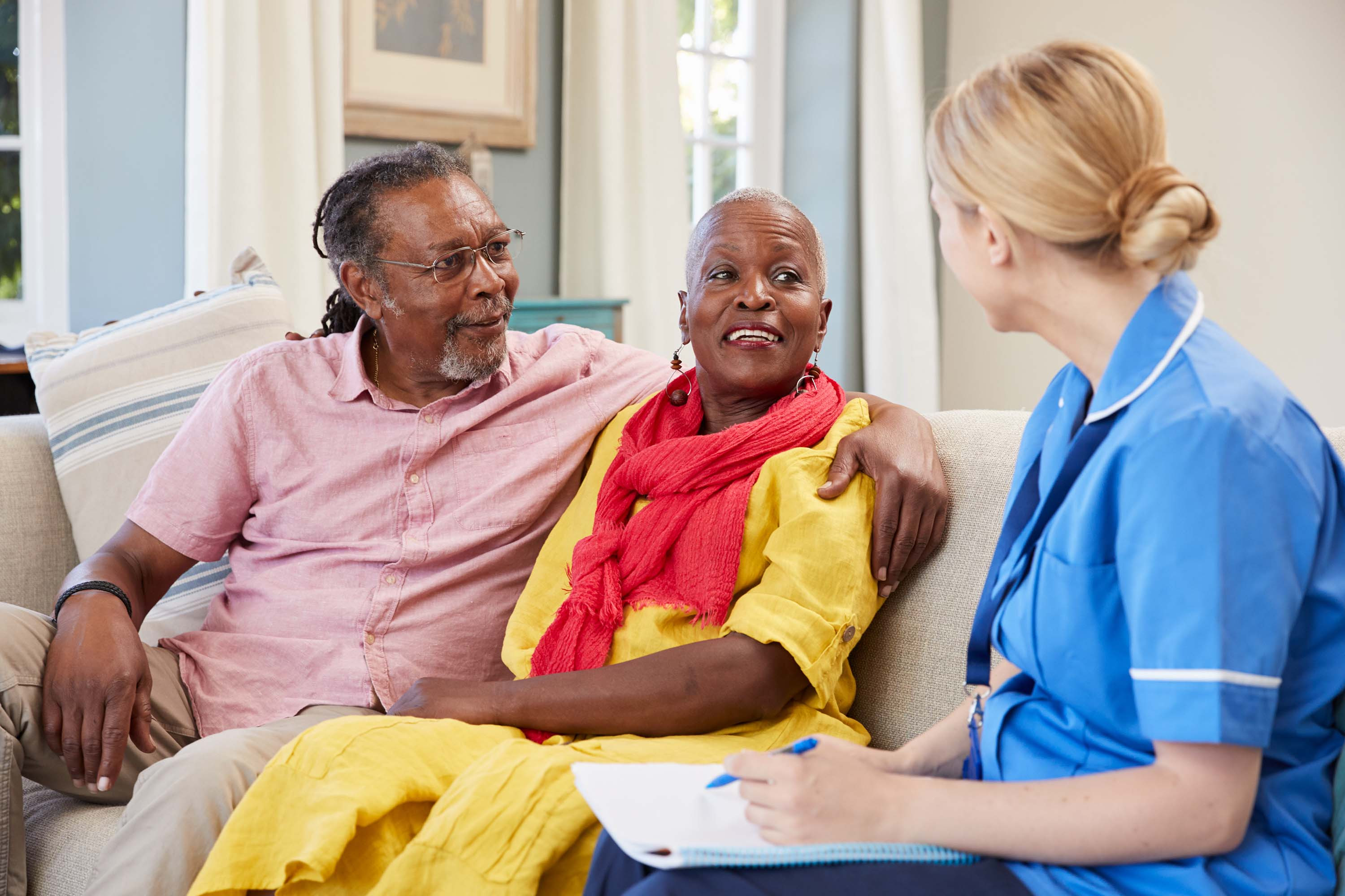Image of a medical professional talking to a woman and a man