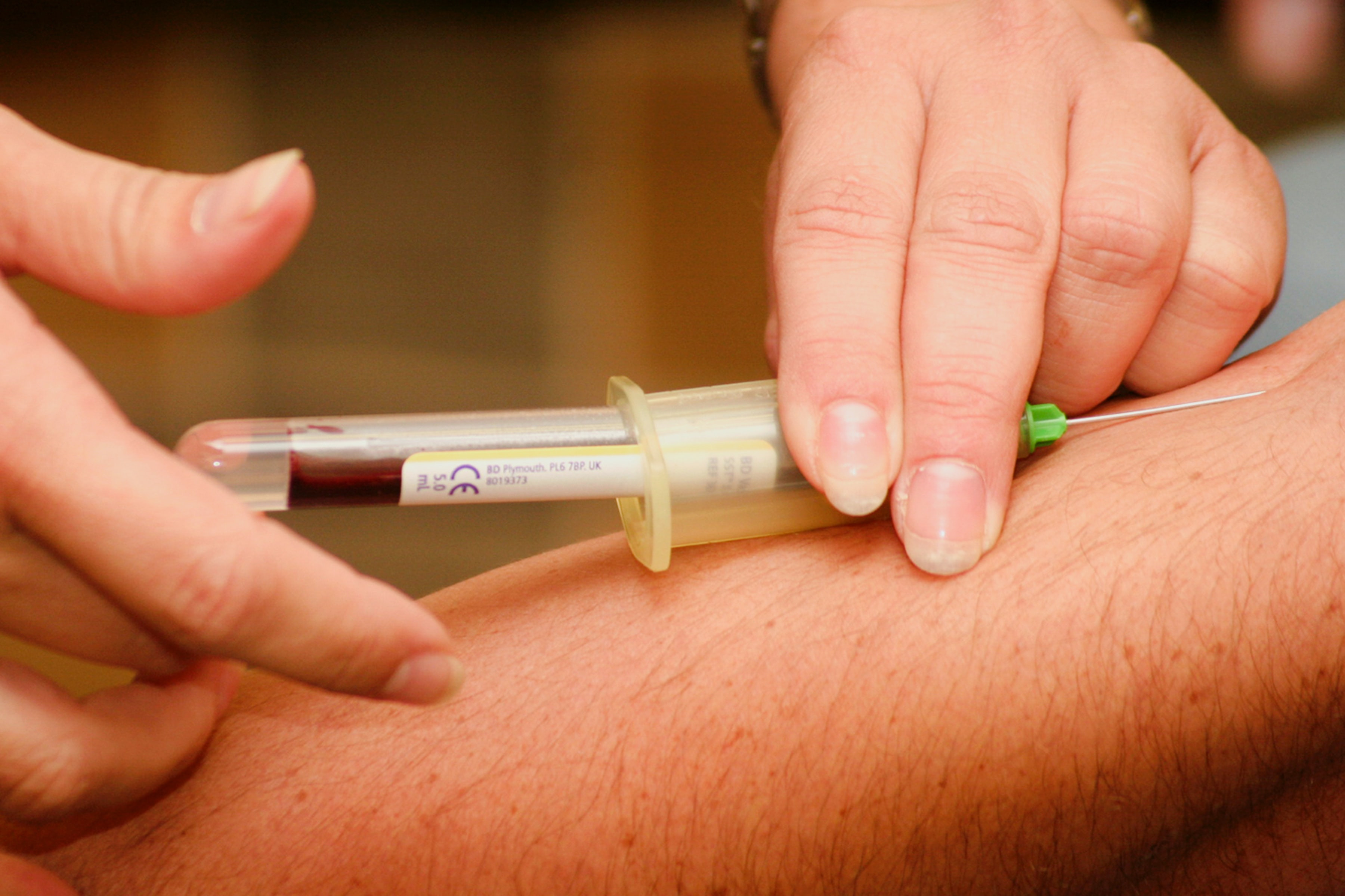 Image of a medical professional taking blood