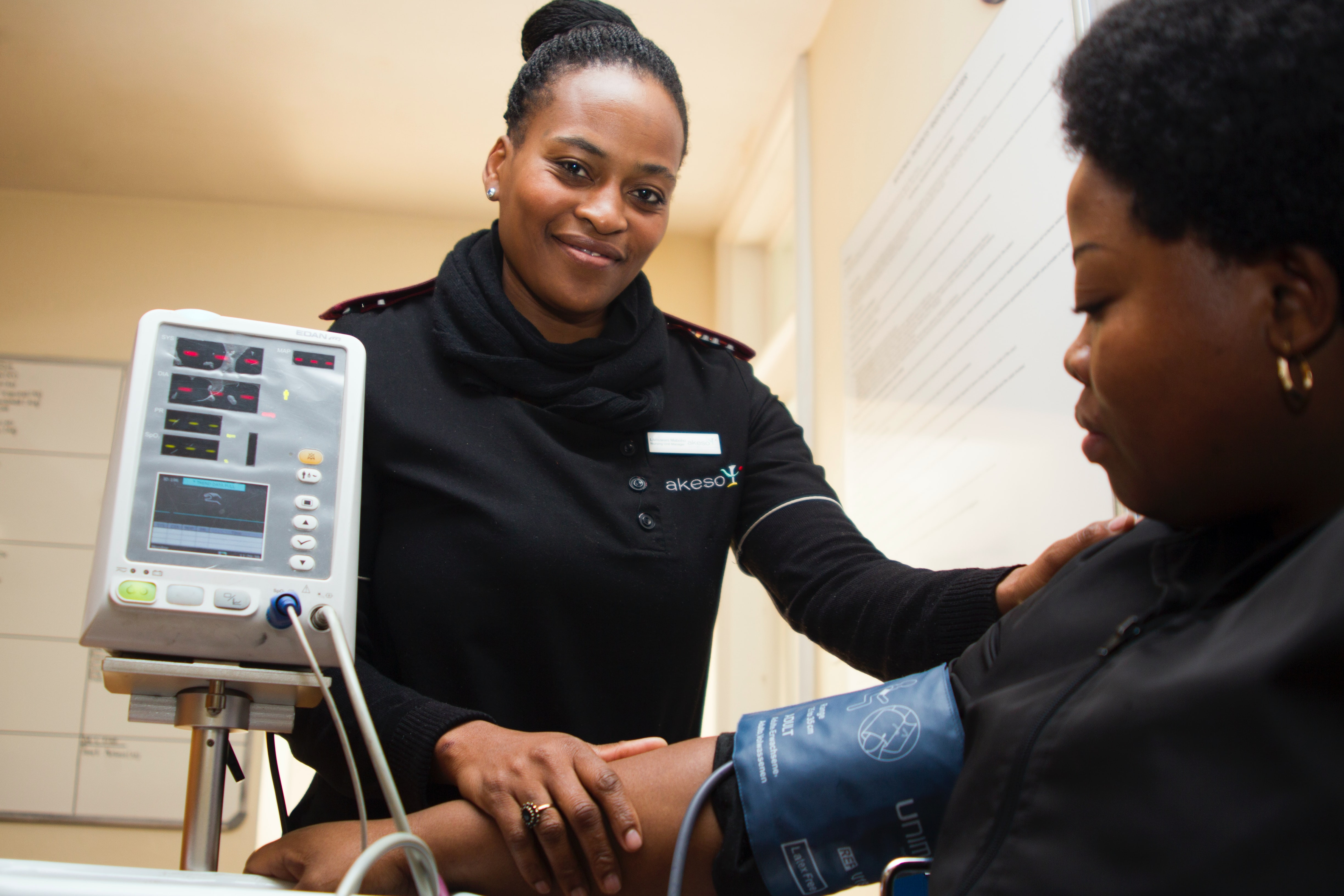 Image of a medical professional taking the blood pressure of a woman